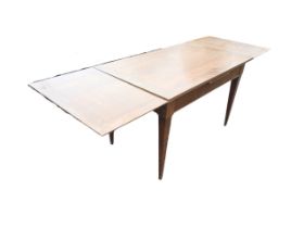 An Italian stained pine and walnut extending dining table by Morelato, the rectangular top with
