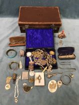 A leather case containing miscellaneous costume jewellery and collectors items - an antique iron