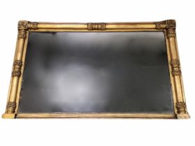 A William IV gilt overmantle mirror, the rectangular plate framed by split turned columns with