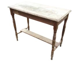 A rectangular late Victorian oak table with moulded top and apron rails, raised on ring-turned