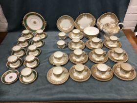 A Victorian porcelain tea service with coffee coloured borders decorated with gilt scrolls and