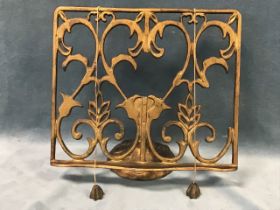 A Victorian gilded cast iron reading stand, the adjustable rectangular foliate scrolled pierced rest