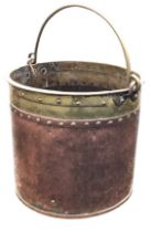 An Victorian arts and crafts copper and brass cylindrical coal bucket, with riveted seams and