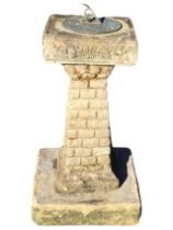 A composition stone garden sundial, with square tapering faux brickwork column on square plinth, the