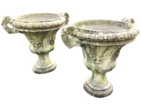 A pair of composition stone urns with lozenge rims and acanthus moulded handles, the bodies with