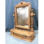 A Victorian style pine dressing table mirror, the shaped crest with applied flowerhead boss above