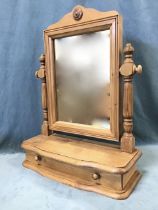 A Victorian style pine dressing table mirror, the shaped crest with applied flowerhead boss above