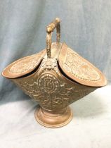 A large nineteenth century copper coal scuttle with twin hinged covers and turned hardwood handle,