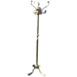 A Victorian style brass coat stand with scrolled hooks mounted on leaf moulded crown, supported on a