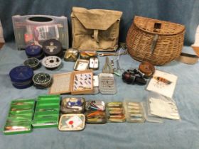 Miscellaneous fishing tackle including a cane creel, tins of spinners, some flies, an otter, a