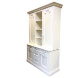 A painted dresser with the dentil cornice above four deep shelves flanked by moulded panelled doors,