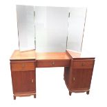 A deco style mahogany dressing table with rectangular mirrors and hinged wings above a kneehole with