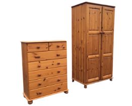 A pine chest of drawers with moulded top above two short and five long knobbed drawers, raised on