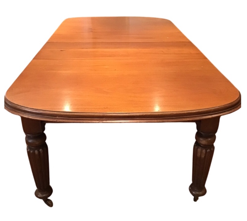 A Victorian mahogany wind-out dining table, the rounded moulded top with three leaves, raised on