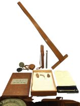 A Stanley leather cased surveyors compass and folding tripod stand; a cased Stanley mapping