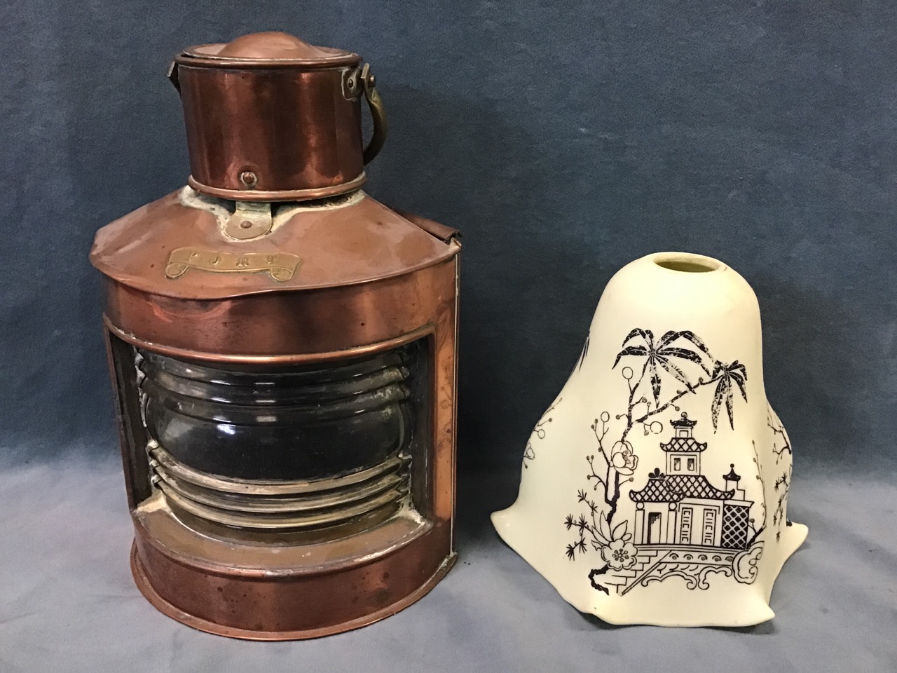 A copper and brass port ships lantern with fresnel lens and sliding door panel - 10in; and a