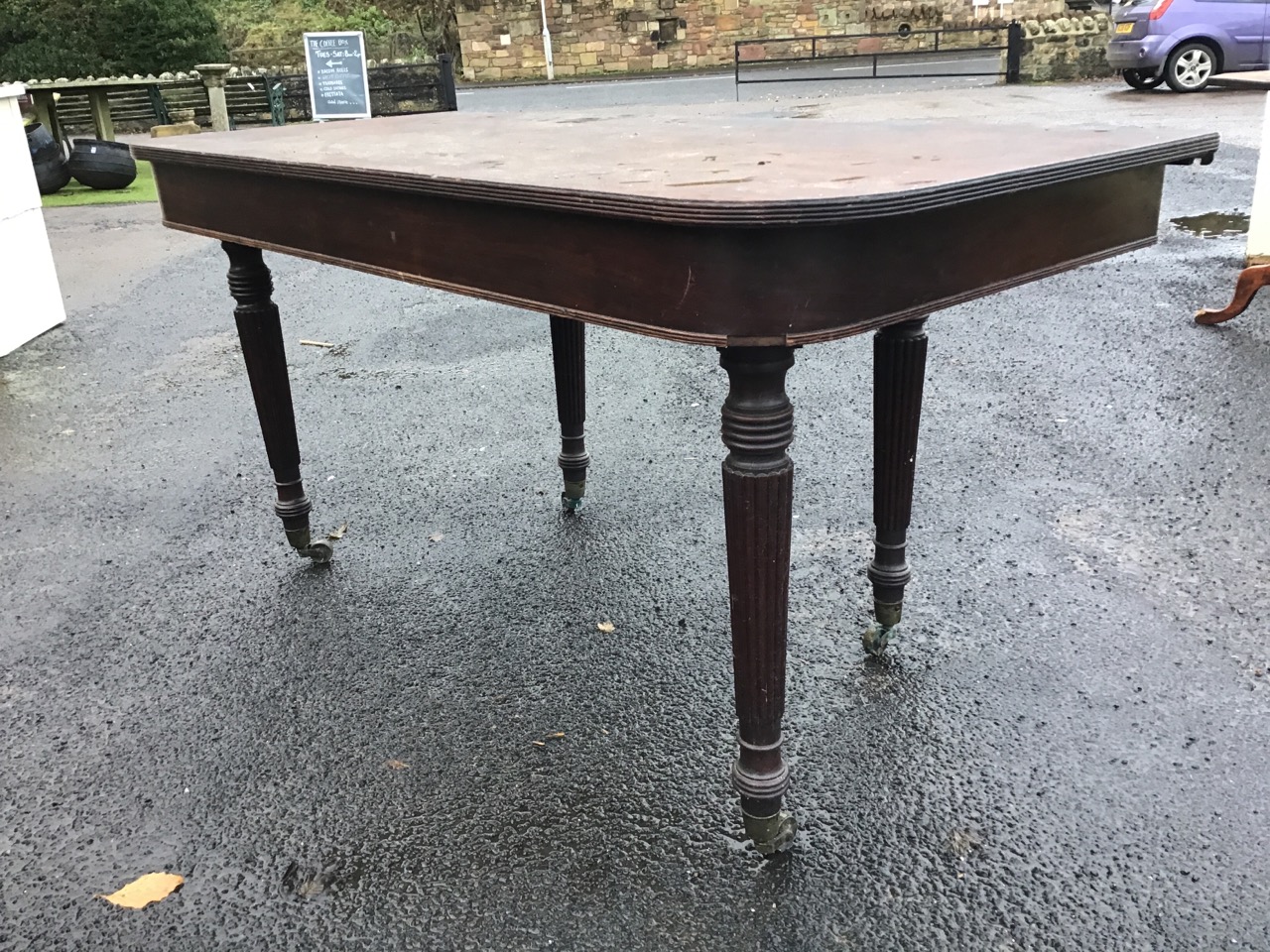 A Regency mahogany table, the rounded rectangular top and apron, raised on turned reeded legs with - Image 3 of 3