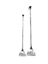 A pair of glass Holophane lampshades of ribbed form with original mounts, hung from chains with