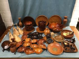 A collection of treen including beech shoe trees, a tortoise shaped covered box, a salad bowl and