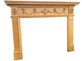 A Georgian style oak chimneypiece with moulded mantleshelf above a dentil band and frieze with