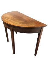 A D-shaped nineteenth century mahogany hall table with single-piece top above a plain frieze, raised