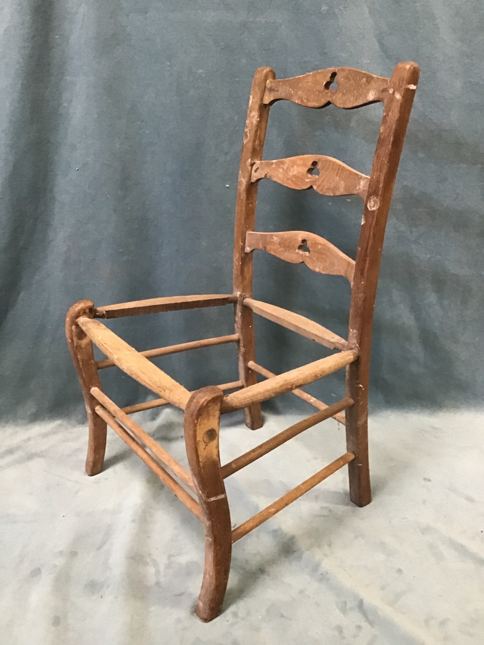 A childs ladderback chair with trefoil pieced rails above a formerly rushed seat; and a Triang - Image 2 of 3