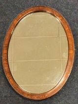 An oval Victorian walnut mirror, the plate in deep cockbeaded frame. (19.25in x 13.75in)