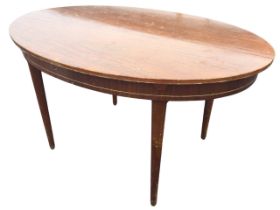 An unusual extending mahogany dining table with integral spare leaf, the oval top with chanelled