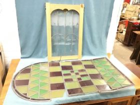A Victorian stained glass arched window panel - 27.25in x 50.5in; and a deco double arched leaded