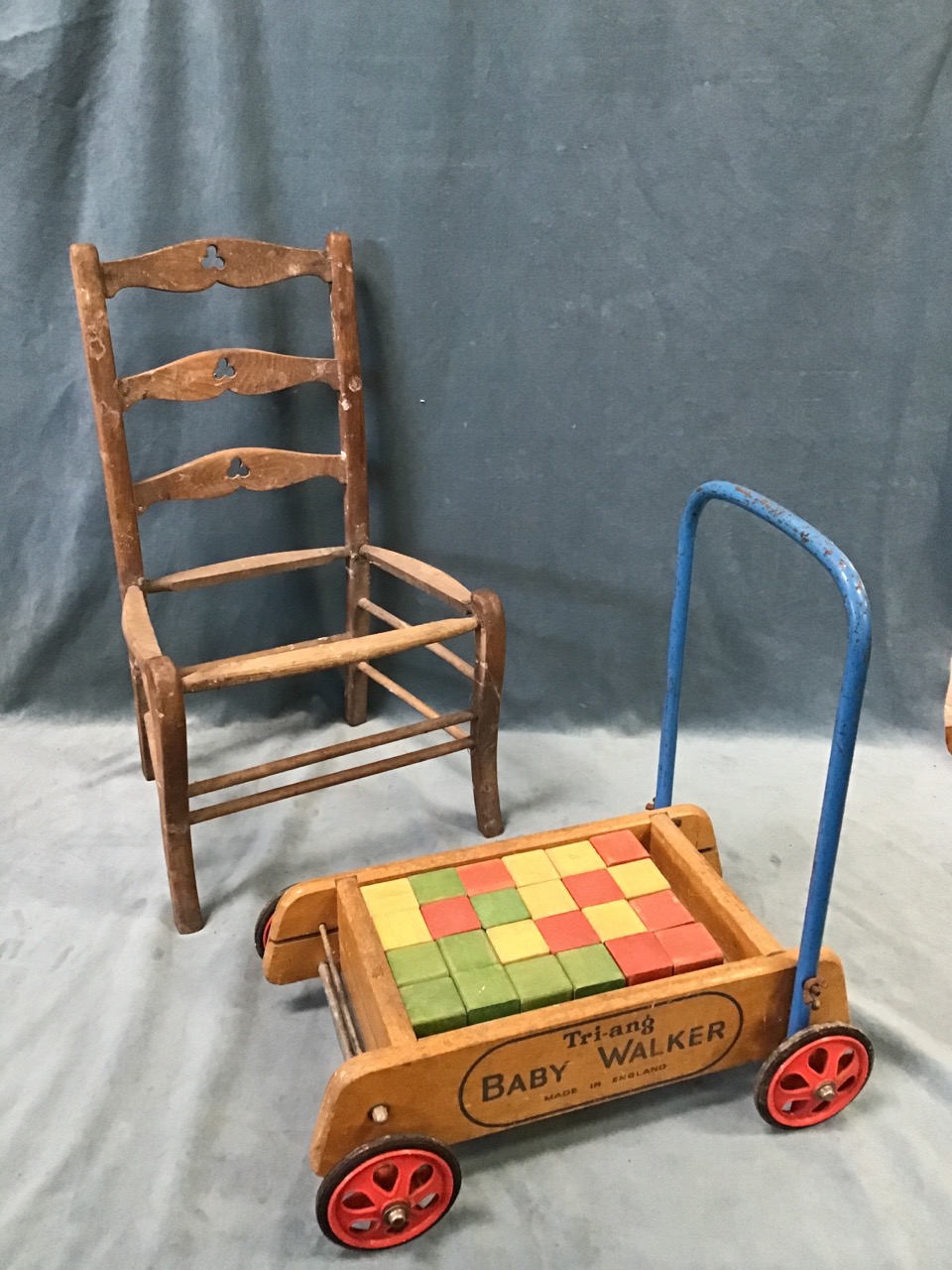 A childs ladderback chair with trefoil pieced rails above a formerly rushed seat; and a Triang