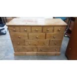 Contemporary pine chest with an arrangement of drawers, 120cm wide, 48.5cm deep, 83cm high
