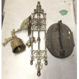 Cast iron boot scraper, cast metal architectural mount and a brass wall mounted bell