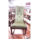 Victorian mahogany rocking chair with green velvet upholstery and scroll arms