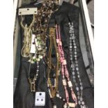 Small group of costume jewellery, mainly bead necklaces on a jewellery hanger