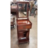 Edwardian mahogany valet/dressing stand with bevelled mirror back, drawer and cupboards below, 46cm