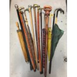 Collection of various walking sticks, umbrellas, canes, including one with silver knop