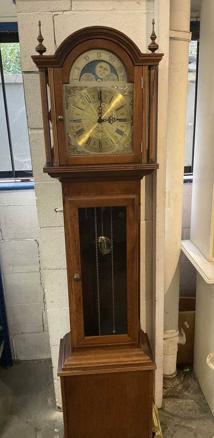 Longcase clock with German 8 day chiming movement, arched brass dial with lunar phase, retailed by F