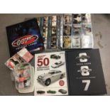Collection of James Bond 007 trading cards, within two folders, plus some loose and two Bond cars bo