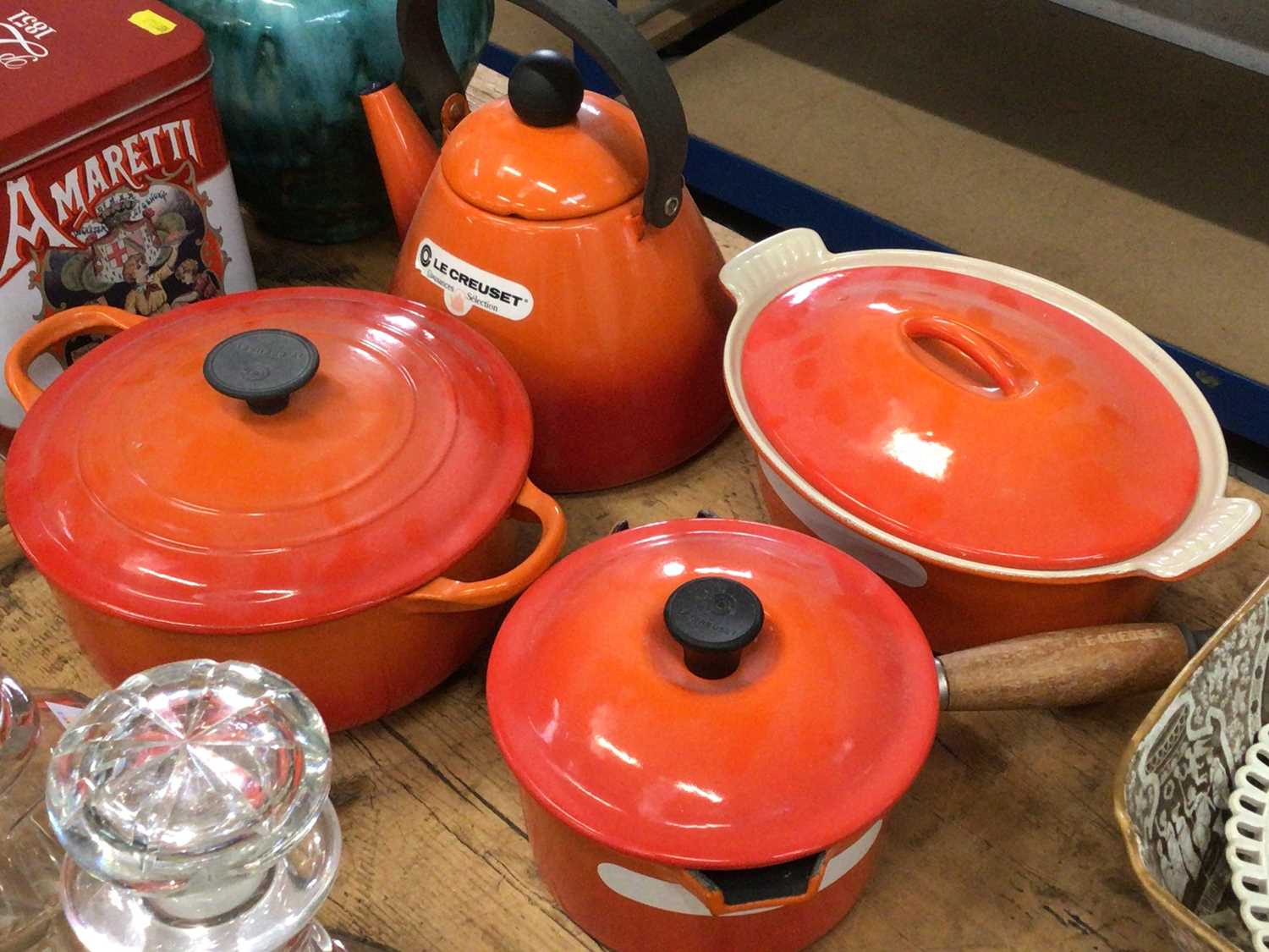 Group of Le Creuset volcano orange kettle and pans