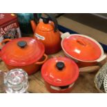 Group of Le Creuset volcano orange kettle and pans
