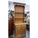 Contemporary narrow pine two height dresser with open shelves, two drawers and cupboards below, 69.5