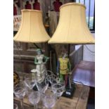 A pair of continental figural pottery lamps with shades