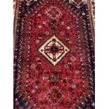 Eastern rug with geometric decoration and central medallion on red, blue and cream ground, 250cm x 1