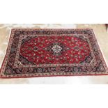 Eastern rug with central medallion and floral decoration on red and blue, 164cm x 99cm