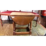 Oak oval drop leaf occasional table on turned and block legs joined by stretchers