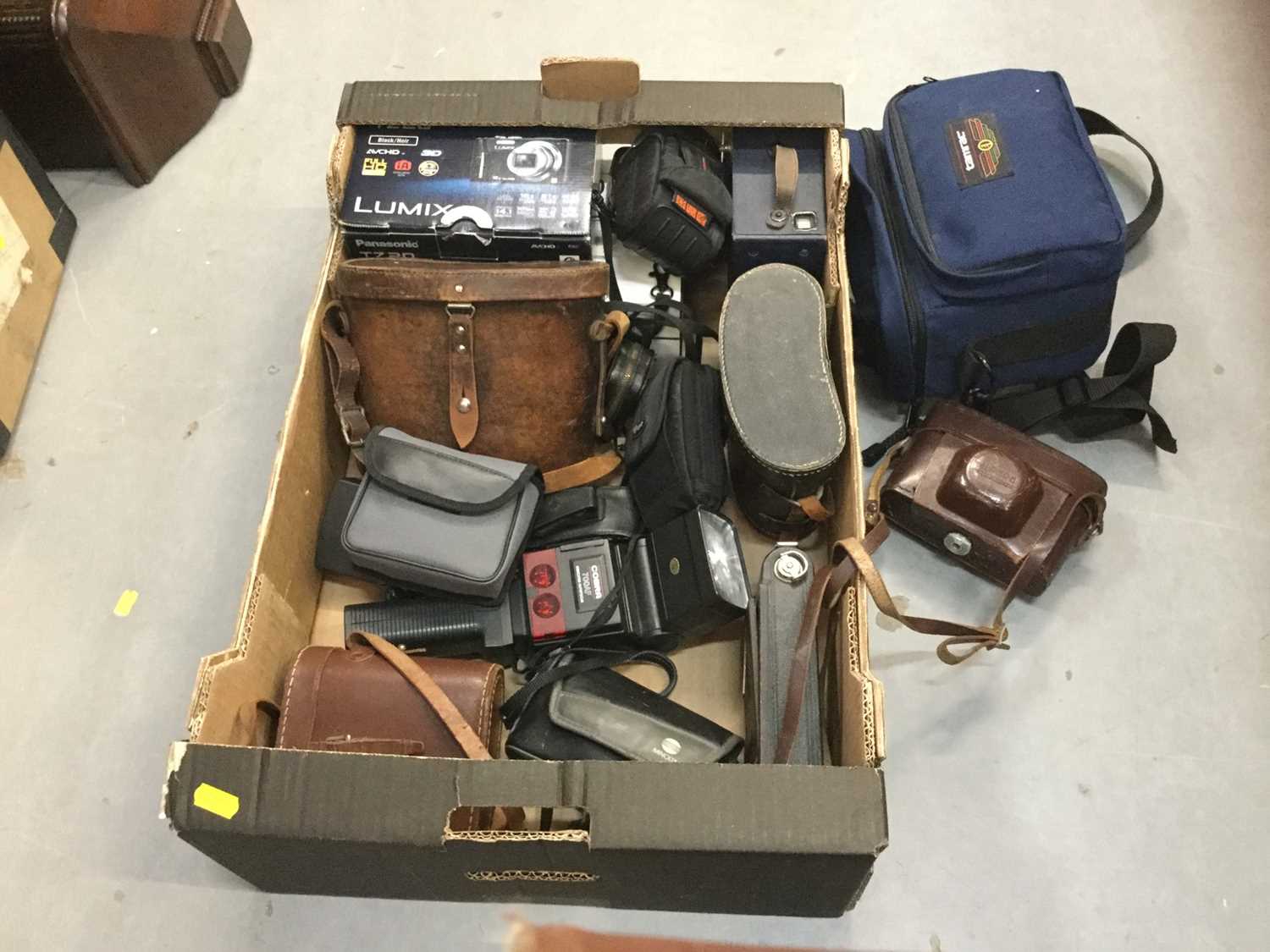 One box containing various cameras and binoculars.