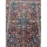 Eastern rug with floral decoration on red and blue ground, 192cm x 137cm