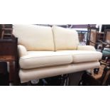 Good quality two seater sofa with cream/yellow upholstery on turned front legs with ceramic castors,