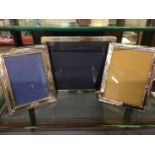 Three silver photograph frames