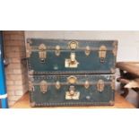 Pair of vintage metal bound trunks with leatherside handles, 90cm wide, 52cm deep, 35cm high